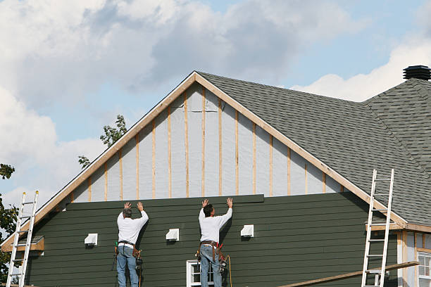Professional Storm Damage Siding Repair technician working in Utica, IN